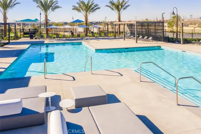 a view of a house with swimming pool and sitting area