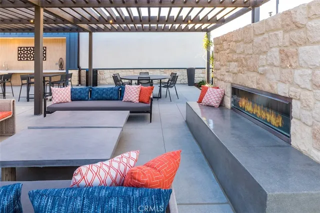 a view of a patio with couches table and chairs with wooden floor