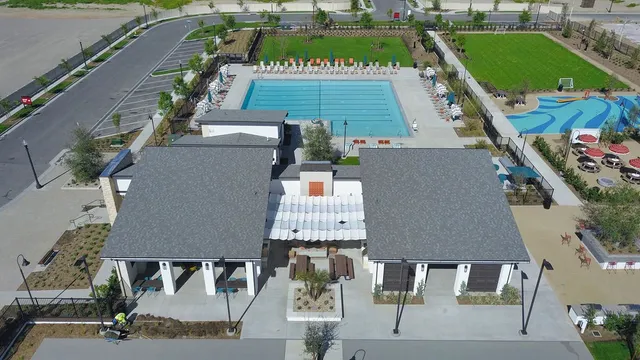 swimming pool view with a garden