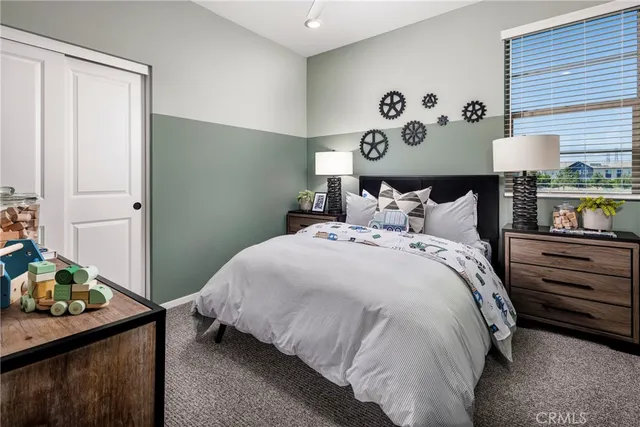 a bedroom with a bed and a mirror