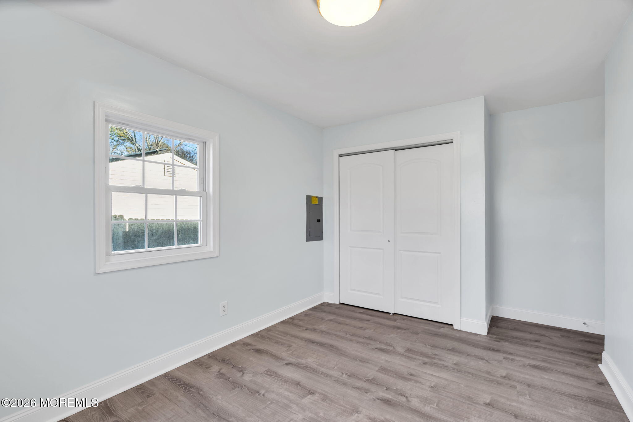 905 Harrison Road Toms River, NJ 08753 - Photo 14 of 41 an empty room with wooden floor and windows