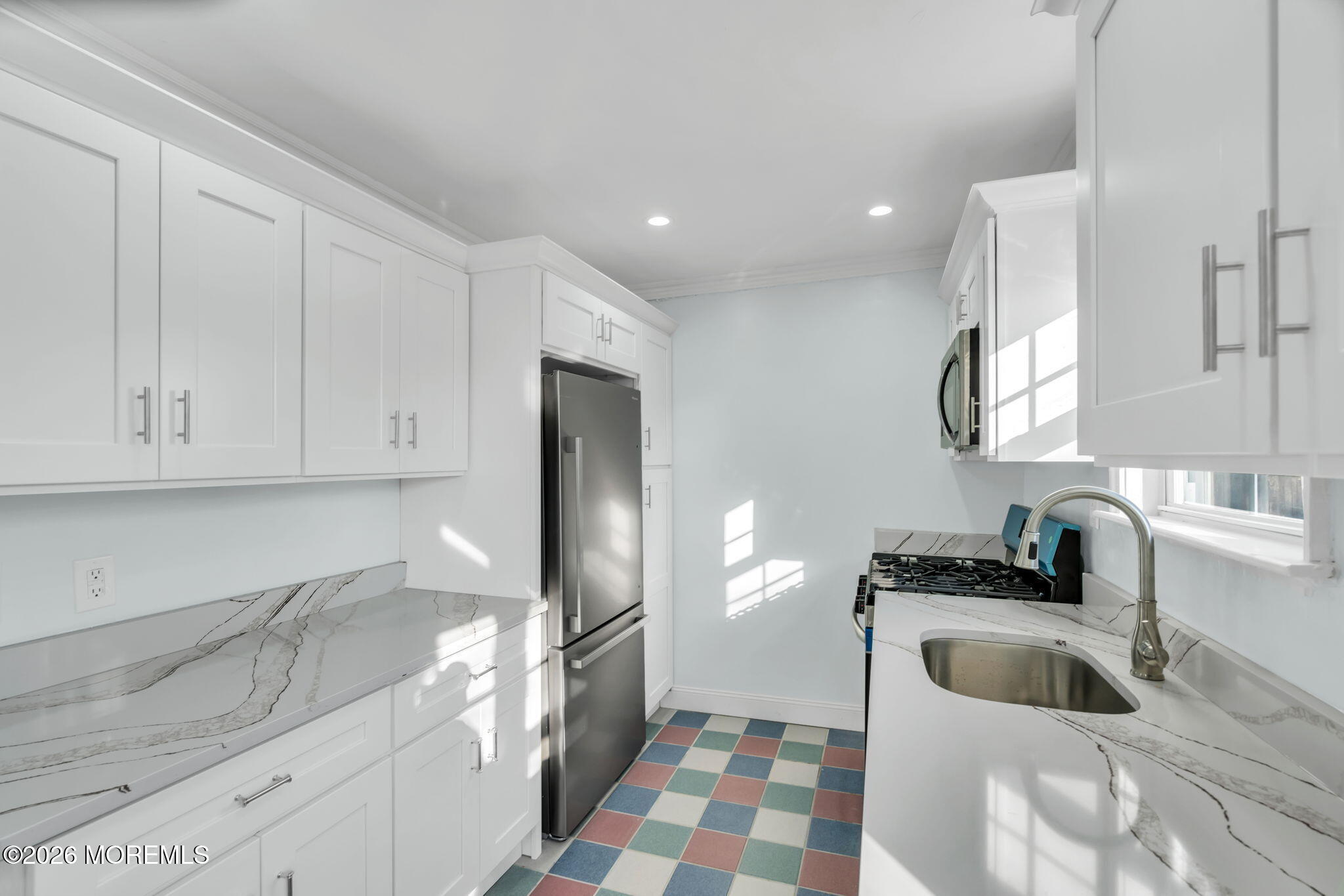 905 Harrison Road Toms River, NJ 08753 - Photo 5 of 41 a kitchen with a sink a refrigerator and cabinets