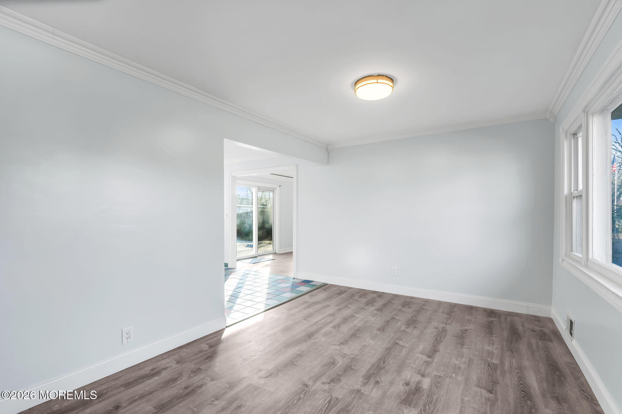 905 Harrison Road Toms River, NJ 08753 - Photo 6 of 41 an empty room with wooden floor and windows