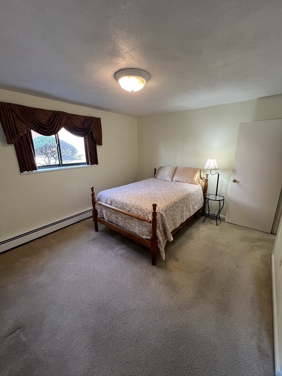 20 Colonial Drive, Unit 3 Andover, MA 01810 - Photo 13 of 24 a bed room with a bed and window
