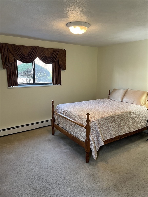 20 Colonial Drive, Unit 3 Andover, MA 01810 - Photo 14 of 24 a bedroom with a bed and a night stand