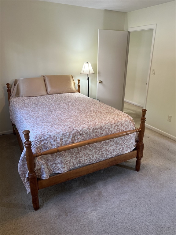 20 Colonial Drive, Unit 3 Andover, MA 01810 - Photo 15 of 24 a bed sitting in a bedroom and table
