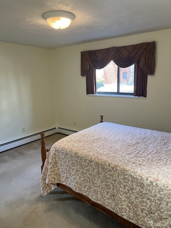 20 Colonial Drive, Unit 3 Andover, MA 01810 - Photo 16 of 24 a bedroom with a bed and window