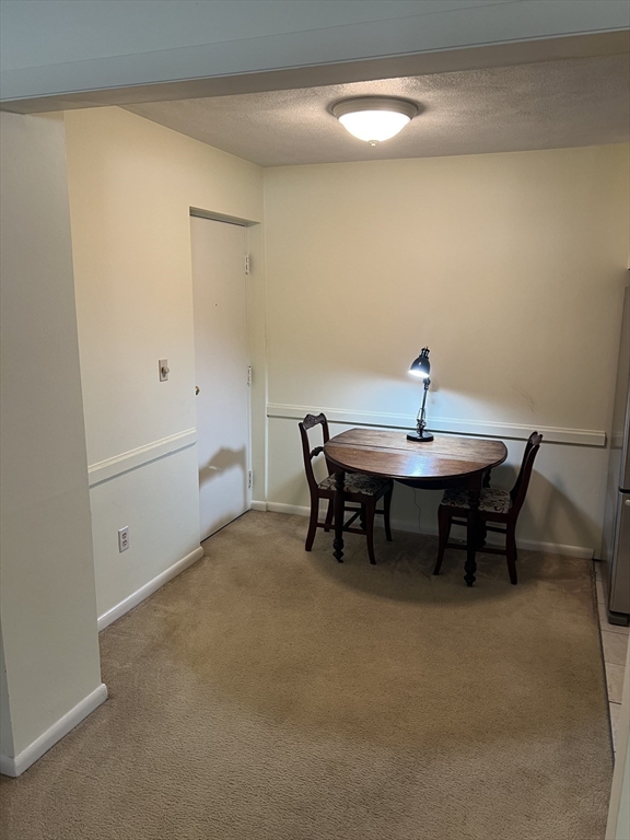 20 Colonial Drive, Unit 3 Andover, MA 01810 - Photo 8 of 24 a view of a dining room with furniture and a chandelier