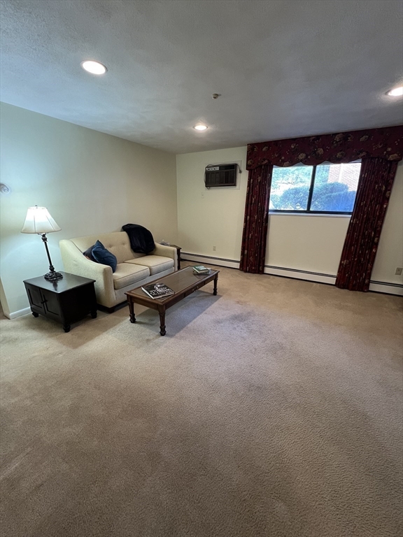 20 Colonial Drive, Unit 3 Andover, MA 01810 - Photo 9 of 24 a living room with large window