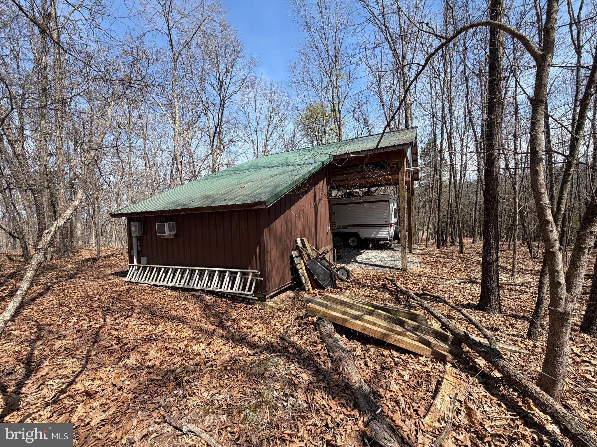 217 Trapper Lane Augusta, WV 26704 - Photo 22 of 111 a view of a wooden house with large trees and wooden fence