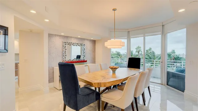 a view of kitchen with stainless steel appliances cabinets and a refrigerator