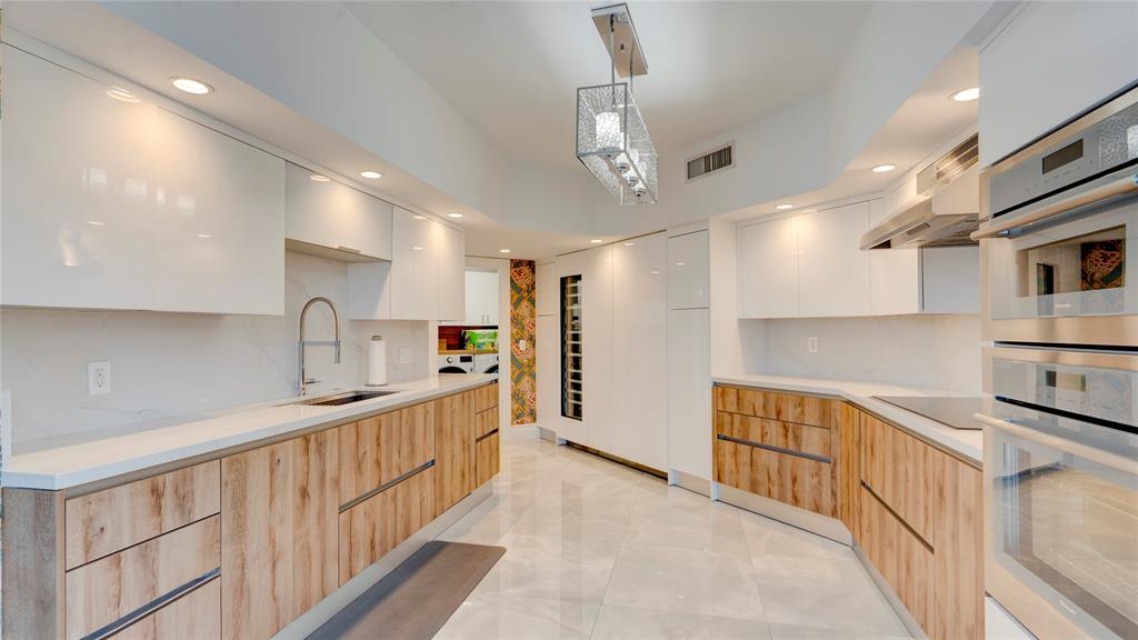 1440 South Ocean Boulevard, Unit 5C Pompano Beach, FL 33062 - Photo 19 of 71 a kitchen with stainless steel appliances a sink and cabinets