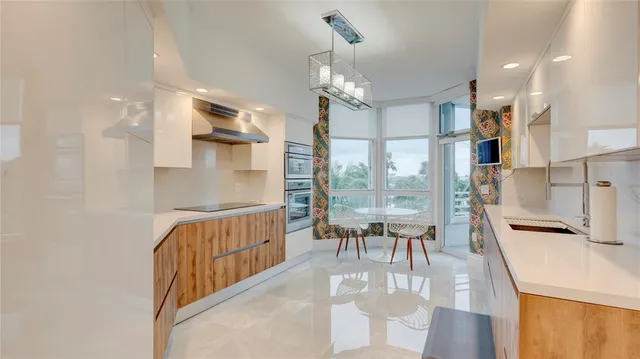 a kitchen with stainless steel appliances granite countertop a refrigerator and a stove