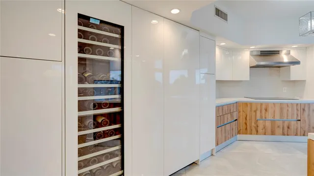 a bedroom with a bed and a flat tv screen next to a window