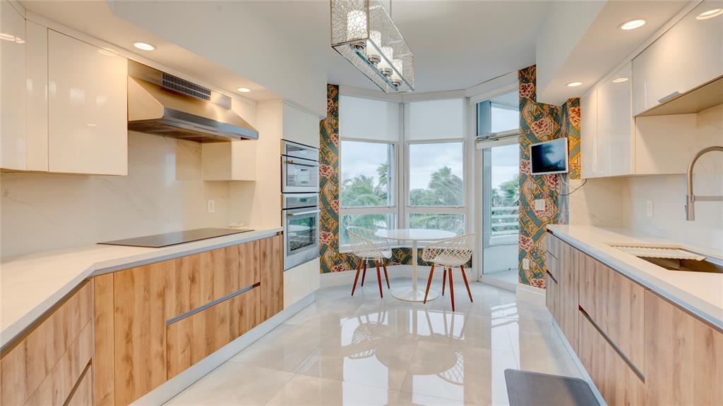 1440 South Ocean Boulevard, Unit 5C Pompano Beach, FL 33062 - Photo 23 of 71 a view of a kitchen with furniture and a large window