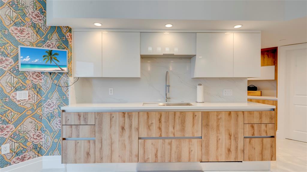 1440 South Ocean Boulevard, Unit 5C Pompano Beach, FL 33062 - Photo 26 of 71 a kitchen with a cabinets and a wooden floor