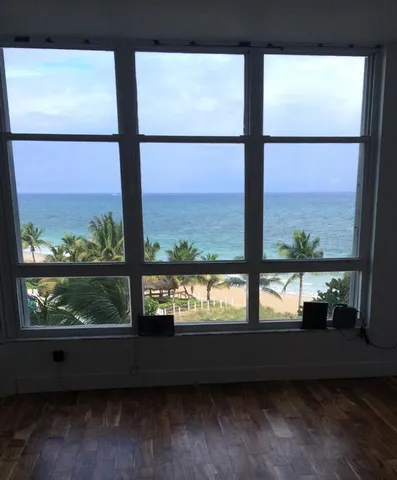 a living room with a couch and a large window