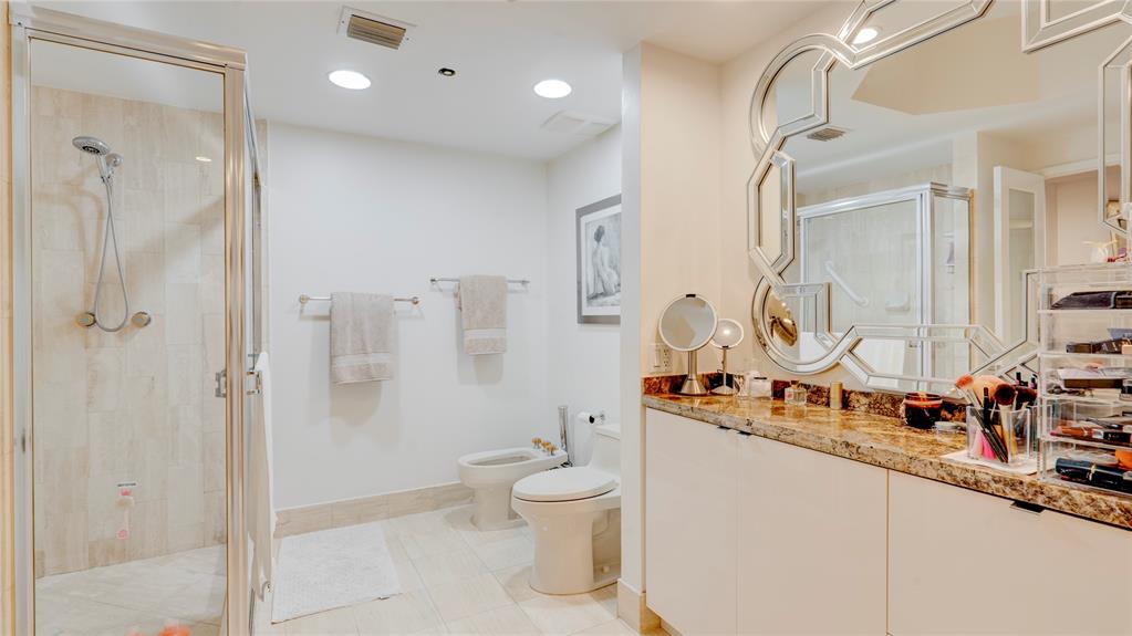 1440 South Ocean Boulevard, Unit 5C Pompano Beach, FL 33062 - Photo 38 of 71 a bathroom with a double vanity sink toilet mirror and shower