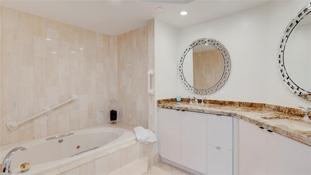 1440 South Ocean Boulevard, Unit 5C Pompano Beach, FL 33062 - Photo 40 of 71 a bathroom with a granite countertop sink a mirror and a bathtub