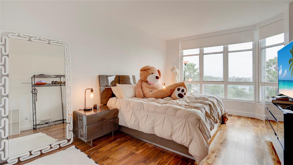 1440 South Ocean Boulevard, Unit 5C Pompano Beach, FL 33062 - Photo 44 of 71 a bed sitting in a bedroom next to a window