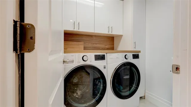 a view of a patio with a table and chairs and potted plants
