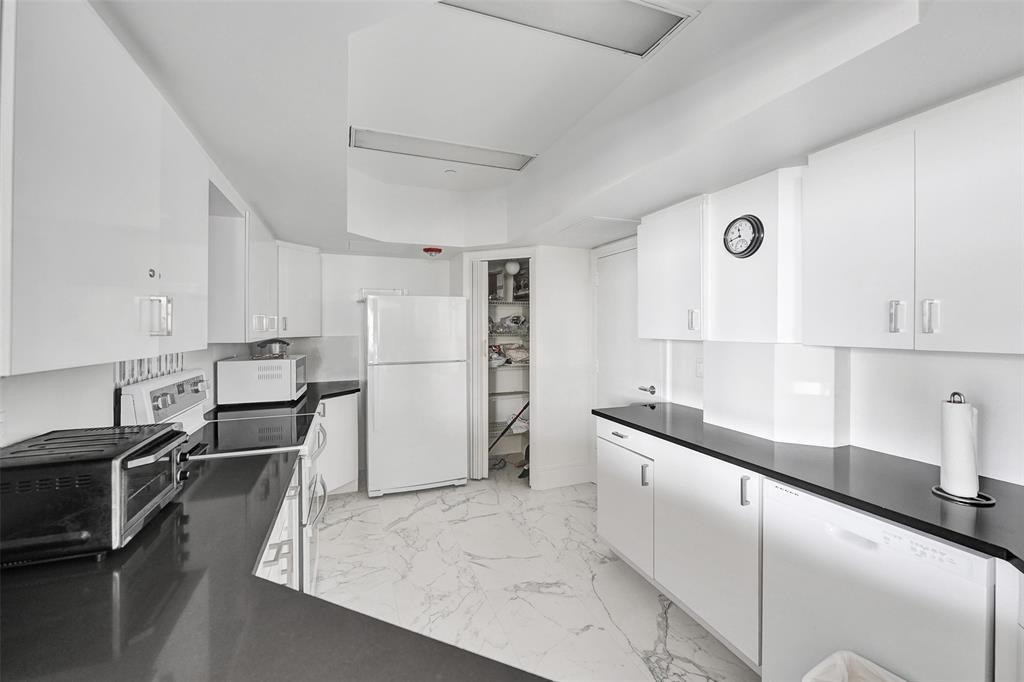 1440 South Ocean Boulevard, Unit 5C Pompano Beach, FL 33062 - Photo 63 of 71 a kitchen with stainless steel appliances granite countertop a sink refrigerator and cabinets