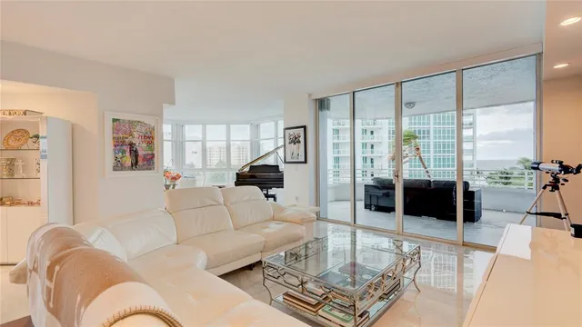 a living room filled with furniture and a large window