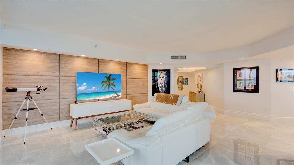 1440 South Ocean Boulevard, Unit 5C Pompano Beach, FL 33062 - Photo 10 of 71 a living room with furniture and a flat screen tv