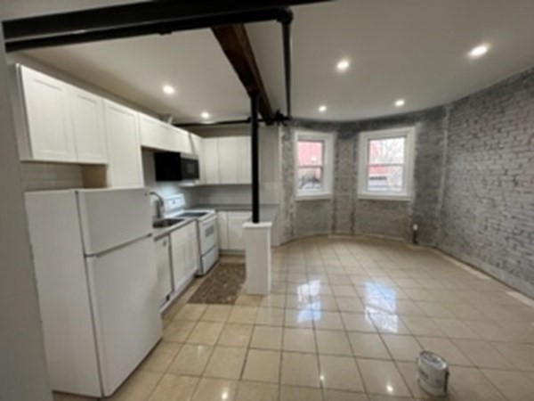 147 Winthrop Road, Unit 2 Brookline, MA 02445 - Photo 17 of 19 a kitchen with stainless steel appliances a refrigerator sink and microwave
