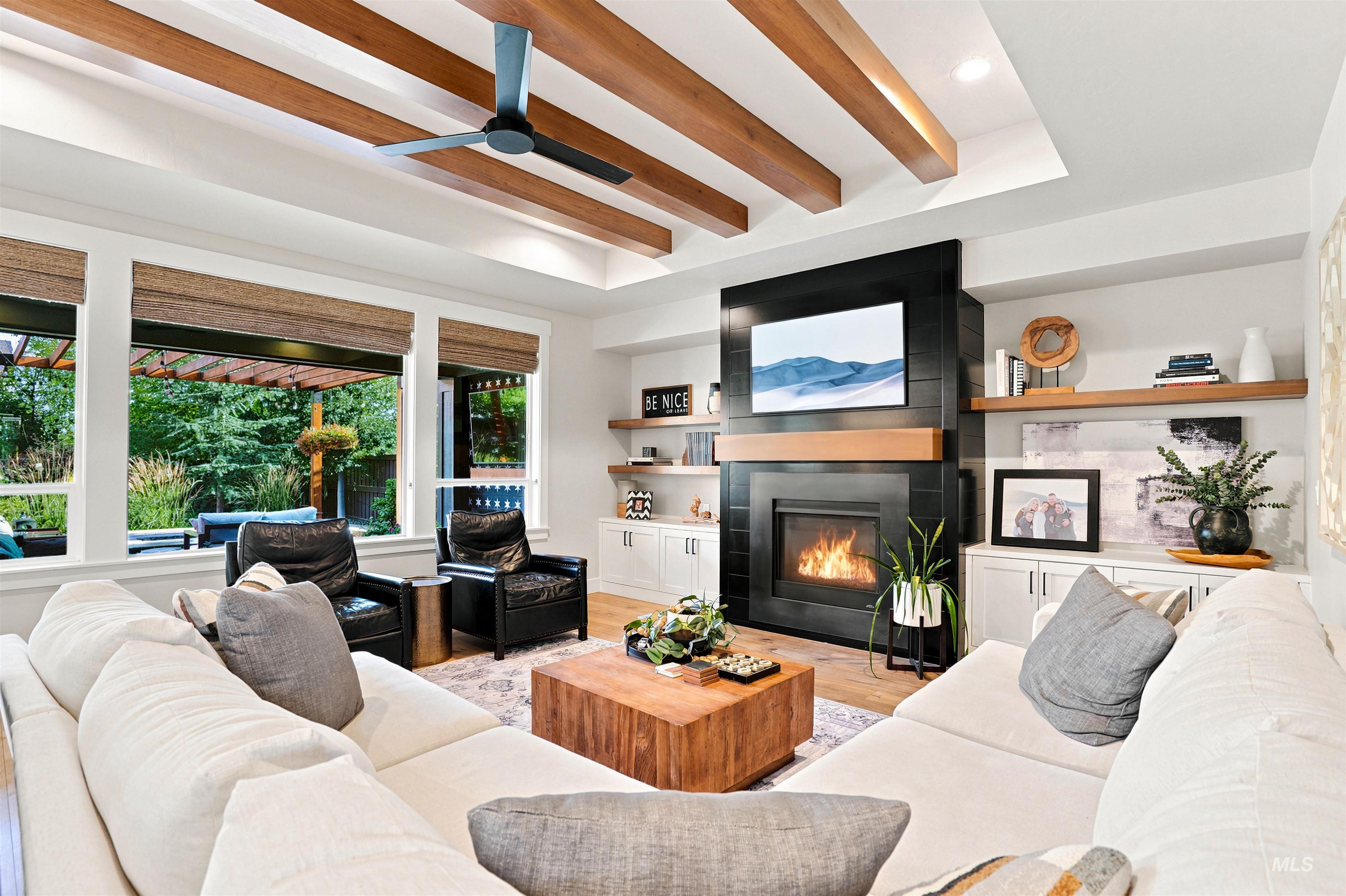 4323 West Ladle Rpds Drive Meridian, ID 83646 - Photo 15 of 49 Living area featuring a coffered ceiling with exposed wood beams and a ceiling fan