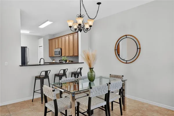 a dining room with furniture a window and a chandelier