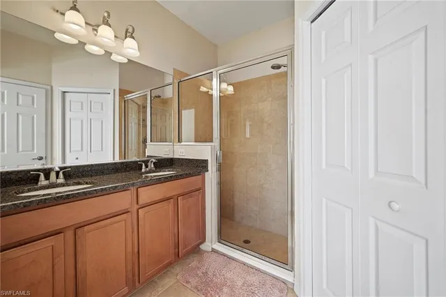 a bathroom with a sink double vanity and a shower