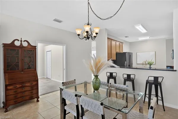 a view of a dining room with furniture and a chandelier