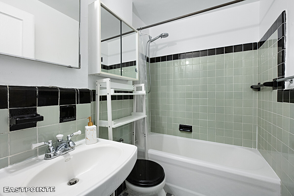 200 West 20th Street, Unit 816 Manhattan, NY 10011 - Photo 4 of 11 a bathroom with a sink a toilet and shower