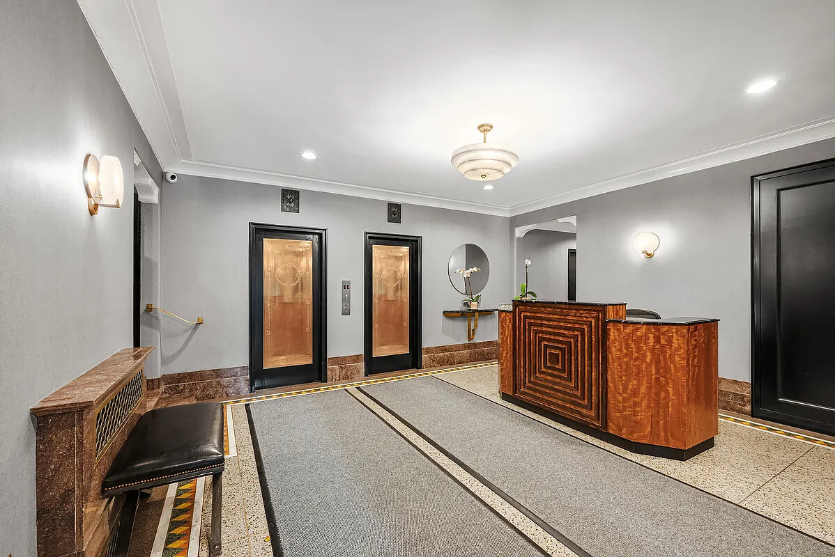 200 West 20th Street, Unit 816 Manhattan, NY 10011 - Photo 5 of 11 a spacious bedroom with a bed and a chandelier