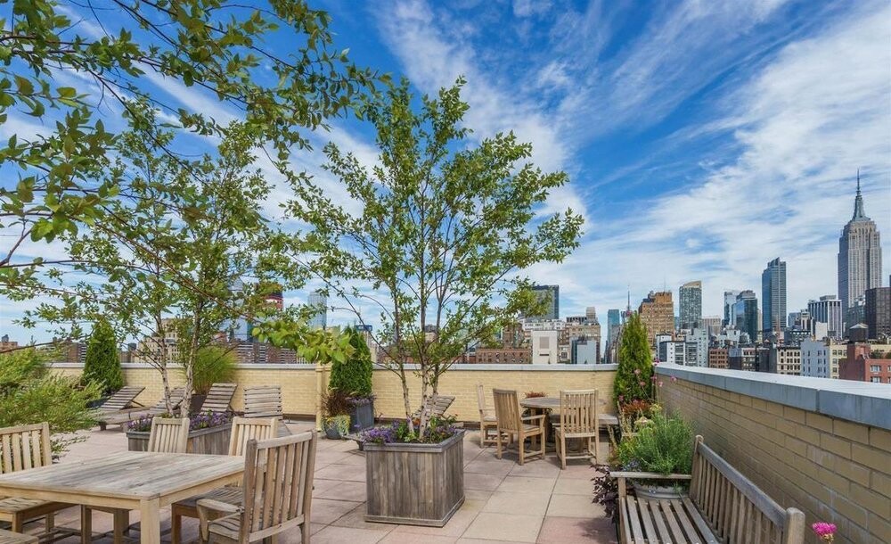 200 West 20th Street, Unit 816 Manhattan, NY 10011 - Photo 6 of 11 a view of a patio with table and chairs and potted plants
