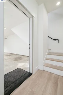 a bedroom with a bed and a large window with balcony view