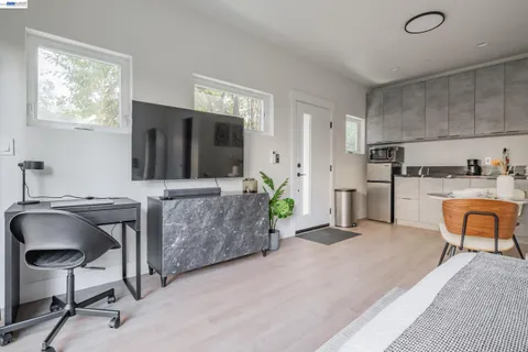 a bedroom with a bed and a television