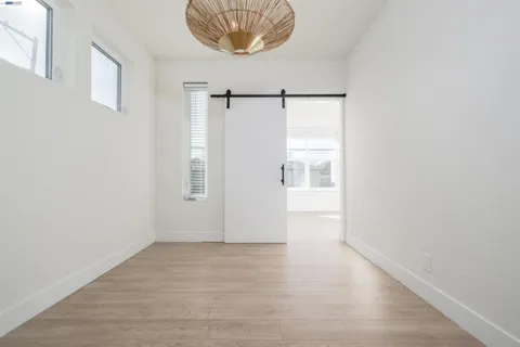 a view of a room with wooden floor