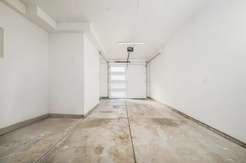 a bedroom with a bed and a large window with balcony view