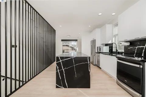 a kitchen with appliances a sink and cabinets
