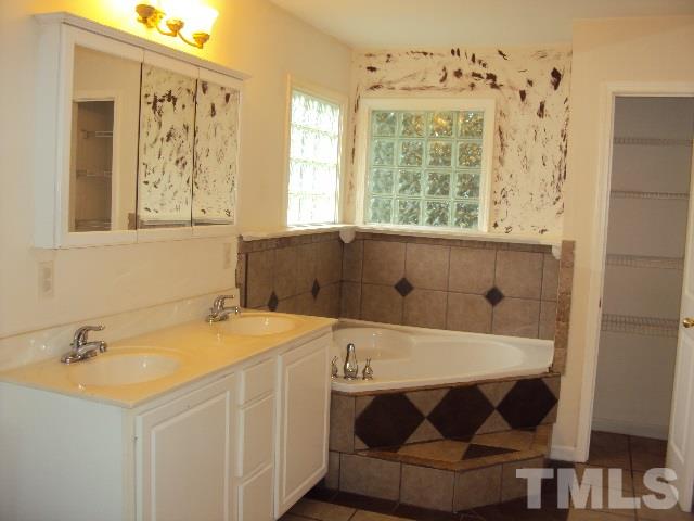 3506 Planet Drive Raleigh, NC 27604 - Photo 12 of 14 a bathroom with a sink and a mirror