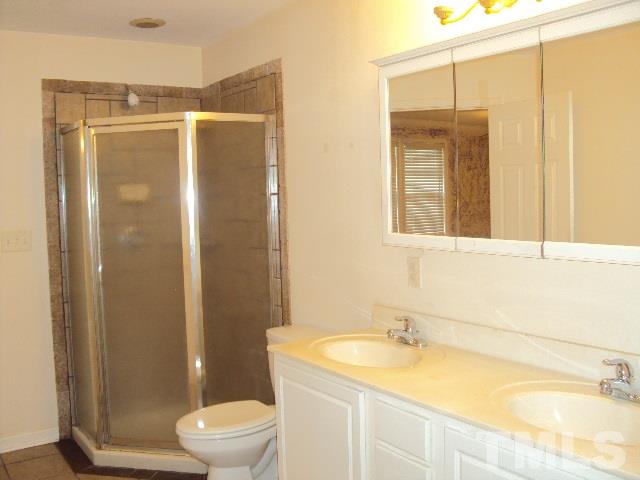 3506 Planet Drive Raleigh, NC 27604 - Photo 13 of 14 a bathroom with a granite countertop sink toilet and shower
