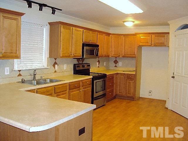 3506 Planet Drive Raleigh, NC 27604 - Photo 3 of 14 a kitchen with a sink a stove and refrigerator