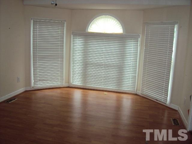 3506 Planet Drive Raleigh, NC 27604 - Photo 5 of 14 an empty room with wooden floor and windows