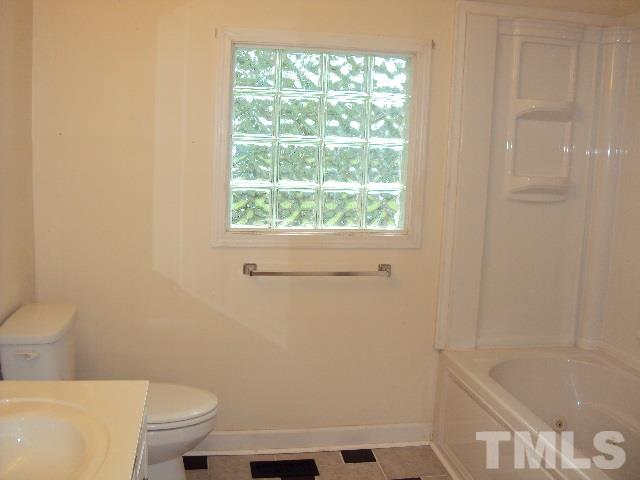 3506 Planet Drive Raleigh, NC 27604 - Photo 10 of 14 a bathroom with a sink a toilet and bathtub
