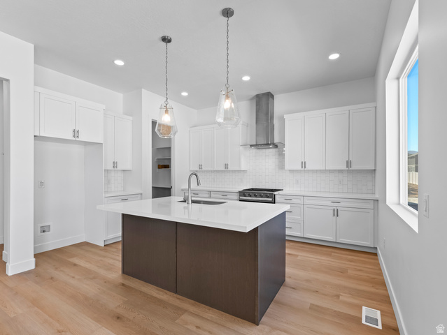 18 South Crimson Way, Unit 304 Mapleton, UT 84664 - Photo 7 of 17 Kitchen with white cabinets, decorative backsplash, a kitchen island with sink, pendant lighting, and recessed lighting