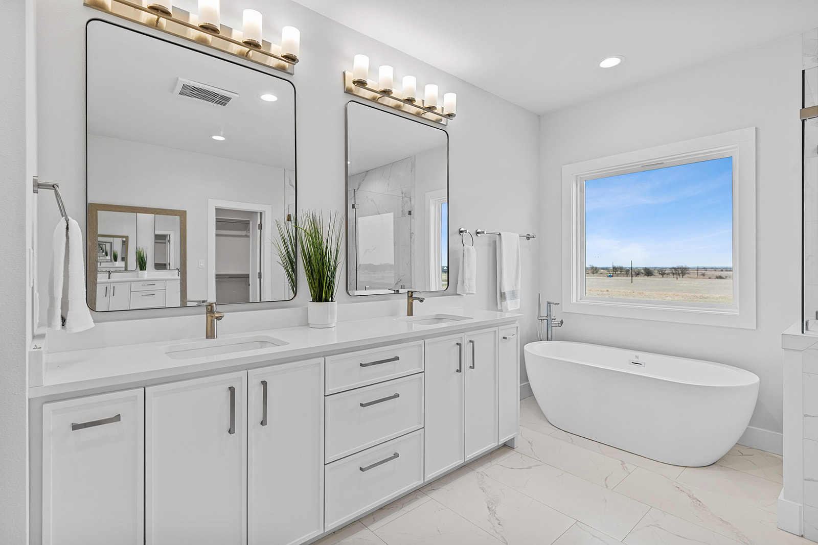 477 Willow Moon Ranch Road Crawford, TX 76638 - Photo 20 of 40 a spacious bathroom with a granite countertop sink and a mirror