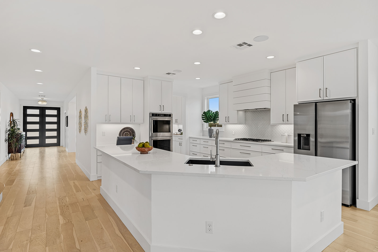 477 Willow Moon Ranch Road Crawford, TX 76638 - Photo 6 of 40 a kitchen with stainless steel appliances kitchen island granite countertop a stove a sink a refrigerator and white cabinets with wooden floor