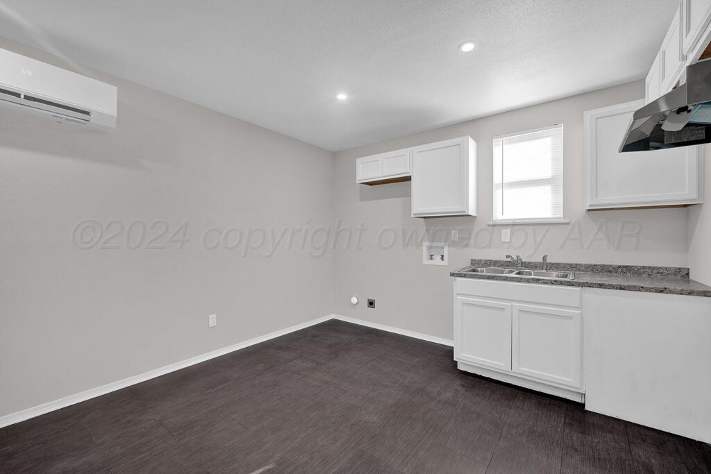 2103 North Marrs Street Amarillo, TX 79107 - Photo 5 of 11 a kitchen with granite countertop white cabinets and a stove